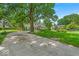 Charming two-story home featuring mature trees and established landscaping, surrounded by a well-maintained lawn at 7502 Colony Cir, Indianapolis, IN 46260
