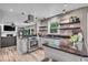 Modern kitchen boasts stainless steel appliances, granite countertops, floating shelves, and open layout into the living room at 7502 Colony Cir, Indianapolis, IN 46260