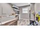 Functional laundry room featuring wood-look tile, shelving, and a sink at 7502 Colony Cir, Indianapolis, IN 46260