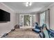 Cozy living room with neutral tones and French doors leading to stairs at 7502 Colony Cir, Indianapolis, IN 46260