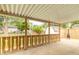 Covered back porch with wooden railing and view of a storage shed and fenced-in yard at 814 N Noble St, Greenfield, IN 46140