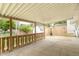 View of the back porch showing concrete flooring, metal ceiling, and a wooden fence at 814 N Noble St, Greenfield, IN 46140