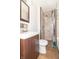 Modern bathroom featuring tiled walk-in shower, wood vanity, and tile flooring at 814 N Noble St, Greenfield, IN 46140
