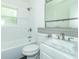 Bathroom features a tiled shower and tub, a modern vanity and a large mirror at 814 N Noble St, Greenfield, IN 46140