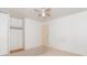 Cozy bedroom includes neutral carpet, a ceiling fan, closet, and a door leading to other parts of the home at 814 N Noble St, Greenfield, IN 46140