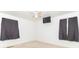 Sunlit bedroom includes a ceiling fan, mounted television, and windows dressed with stylish dark curtains at 814 N Noble St, Greenfield, IN 46140