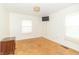 Bright bedroom offers hard wood floors and a mounted television at 814 N Noble St, Greenfield, IN 46140