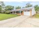 Single-story brick home with covered porch, attached garage, and a concrete driveway at 814 N Noble St, Greenfield, IN 46140