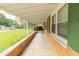 Covered front porch with brick base and view of the landscaped front yard at 814 N Noble St, Greenfield, IN 46140