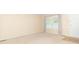 Bright living room with neutral carpet, a large window, and a white interior door at 814 N Noble St, Greenfield, IN 46140