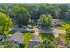 An aerial view of a residential street surrounded by mature trees shows the charm and tranquility of the neighborhood at 834 Delray Dr, Indianapolis, IN 46241
