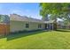 Spacious backyard with lush green grass and a screened porch providing a relaxing outdoor space at 834 Delray Dr, Indianapolis, IN 46241