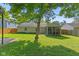 Enjoy the outdoors in this backyard featuring mature trees, a green lawn, and a screened porch at 834 Delray Dr, Indianapolis, IN 46241