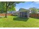 Beautiful backyard with a well-kept lawn and an inviting screened porch for outdoor relaxation at 834 Delray Dr, Indianapolis, IN 46241