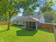 A serene backyard featuring a screened-in porch and privacy fence at 834 Delray Dr, Indianapolis, IN 46241