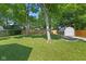 Large backyard featuring a storage shed, mature trees, and wooden fencing for privacy and outdoor enjoyment at 834 Delray Dr, Indianapolis, IN 46241