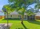A view of a well-maintained backyard and screen porch at 834 Delray Dr, Indianapolis, IN 46241