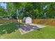 Spacious backyard with shed, basketball hoop, and a wooden fence, perfect for recreation and privacy at 834 Delray Dr, Indianapolis, IN 46241