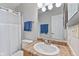 A well-lit bathroom featuring a shower and sink at 834 Delray Dr, Indianapolis, IN 46241