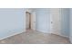 A view of a light blue bedroom featuring two doors at 834 Delray Dr, Indianapolis, IN 46241