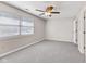 Well-lit bedroom featuring neutral tones, soft carpeting, ceiling fan, and a window with bright natural light at 834 Delray Dr, Indianapolis, IN 46241