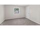 A well-lit bedroom with gray carpet and a window at 834 Delray Dr, Indianapolis, IN 46241