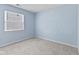 A cozy bedroom featuring light blue walls and carpet at 834 Delray Dr, Indianapolis, IN 46241