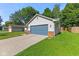 Cozy single-story home featuring a blue garage door, light siding, brick accents, and green lawn at 834 Delray Dr, Indianapolis, IN 46241