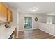 Well-lit kitchen with oak cabinets and vinyl flooring with access to outdoor patio at 834 Delray Dr, Indianapolis, IN 46241