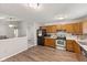 Bright kitchen with oak cabinets, stainless steel appliances, and attractive vinyl flooring at 834 Delray Dr, Indianapolis, IN 46241
