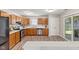 Functional kitchen with oak cabinets, modern stainless steel appliances, and sleek vinyl flooring at 834 Delray Dr, Indianapolis, IN 46241