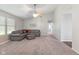 Inviting living room featuring a gray sectional sofa, a ceiling fan, and neutral carpet at 834 Delray Dr, Indianapolis, IN 46241