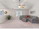 Spacious living room featuring carpet, a ceiling fan, and ample natural light at 834 Delray Dr, Indianapolis, IN 46241