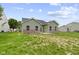 Backyard featuring a concrete patio and green grass at 8355 Fieldfare Way, Indianapolis, IN 46237