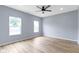 Bedroom features a ceiling fan, wood floors, and windows that provide natural light at 8355 Fieldfare Way, Indianapolis, IN 46237