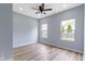 Bedroom features a ceiling fan, wood floors, and windows that provide natural light at 8355 Fieldfare Way, Indianapolis, IN 46237