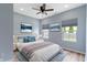 Serene bedroom featuring large windows, modern decor, recessed lights, and neutral tones, providing a peaceful ambiance at 8355 Fieldfare Way, Indianapolis, IN 46237