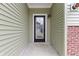 Inviting front entryway featuring a stylish door with glass inserts, side panel, and brick accent, creating a warm welcome at 8355 Fieldfare Way, Indianapolis, IN 46237