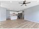 A bright kitchen with white cabinets, stainless steel appliances, and a center island with a breakfast bar at 8355 Fieldfare Way, Indianapolis, IN 46237