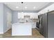 A bright kitchen featuring white cabinets, subway tile backsplash, stainless appliances, and a center island at 8355 Fieldfare Way, Indianapolis, IN 46237