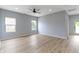 An open concept living room featuring light gray walls, light wood flooring, recessed lighting, and a ceiling fan at 8355 Fieldfare Way, Indianapolis, IN 46237