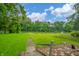 Scenic backyard view with lush greenery, a river, and a patio dining set for outdoor enjoyment at 8842 S Pleasure Valley Rd, Waldron, IN 46182