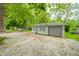 Spacious detached two car garage with lots of parking space and some trees in the front at 8842 S Pleasure Valley Rd, Waldron, IN 46182