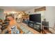 Inviting living room featuring a brick fireplace, hardwood floors, and a large TV at 8842 S Pleasure Valley Rd, Waldron, IN 46182