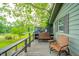 Cozy porch area furnished with chairs and bench, overlooking a serene river view at 8842 S Pleasure Valley Rd, Waldron, IN 46182