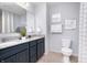 Well-lit bathroom with a double vanity, granite countertops, and a separate toilet area for added privacy at 900 Cowley Dr, Westfield, IN 46074