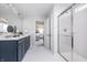 Bright bathroom featuring a glass shower, modern vanity, and stylish tile flooring, leading to the bedroom at 900 Cowley Dr, Westfield, IN 46074