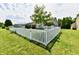 Spacious fenced backyard with lush green grass, mature tree, and white vinyl fencing at 9022 Hosta Way, Camby, IN 46113