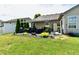 Outdoor patio with seating, awning, and landscaped backyard provides a perfect space for relaxation and entertaining at 9022 Hosta Way, Camby, IN 46113
