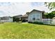 Beautiful backyard featuring lush green space, manicured landscaping, and a charming white picket fence at 9022 Hosta Way, Camby, IN 46113